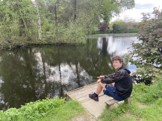 boy fishing by a lake
